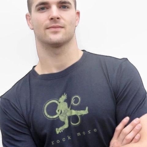 Classic fit 'Rock More' men's guitar T-shirt in navy bamboo cotton blend, featuring green rock and roll graphic, worn by male model.