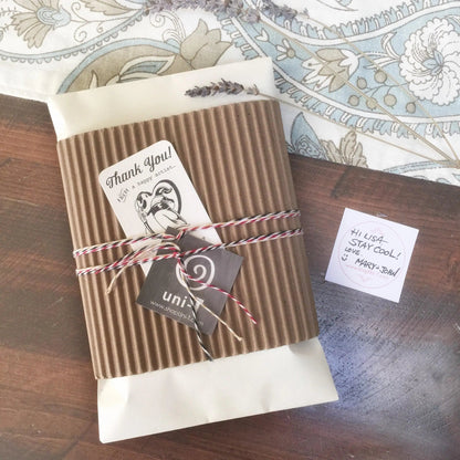 Eco-friendly empowerment tote bag gift wrapped in kraft paper with twine and thank-you tag, perfect for sustainable gifting occasions.