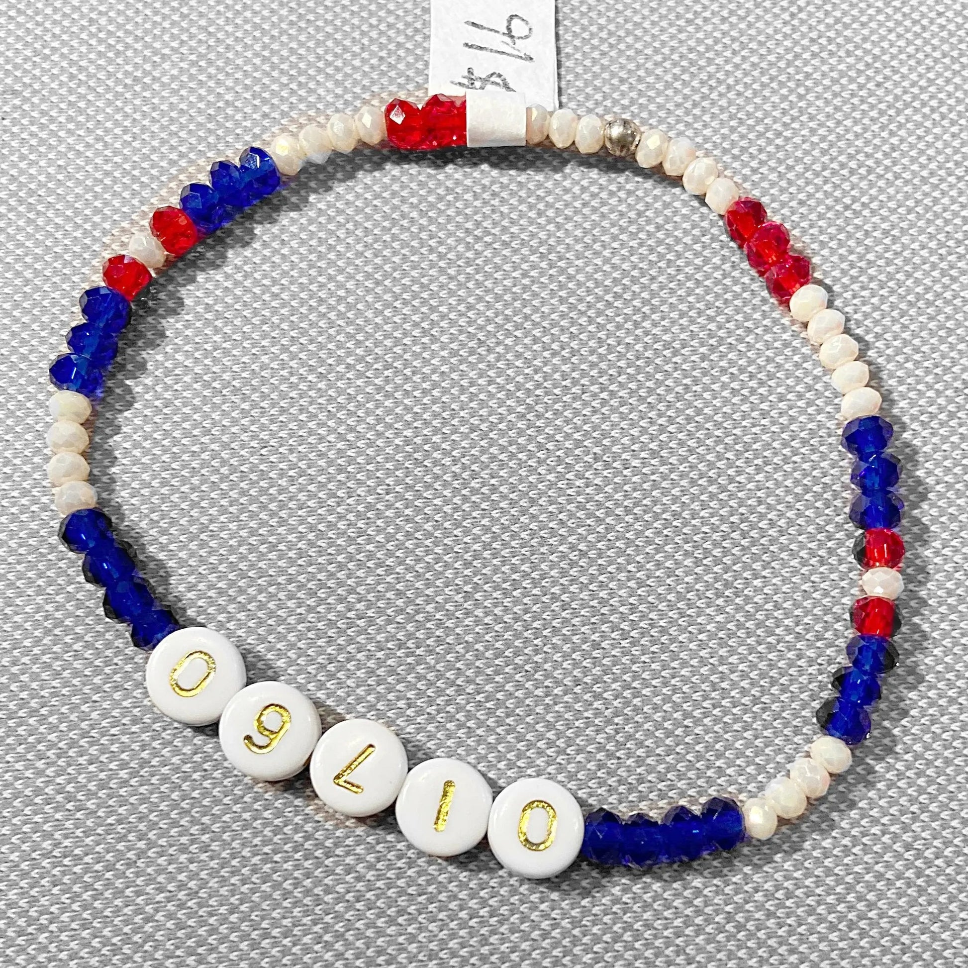 Natick Town Bracelets - Custom Word Bracelets featuring red, white, and blue crystal beads with '01760' in gold letters. Ideal for school pride or personalized gifts.