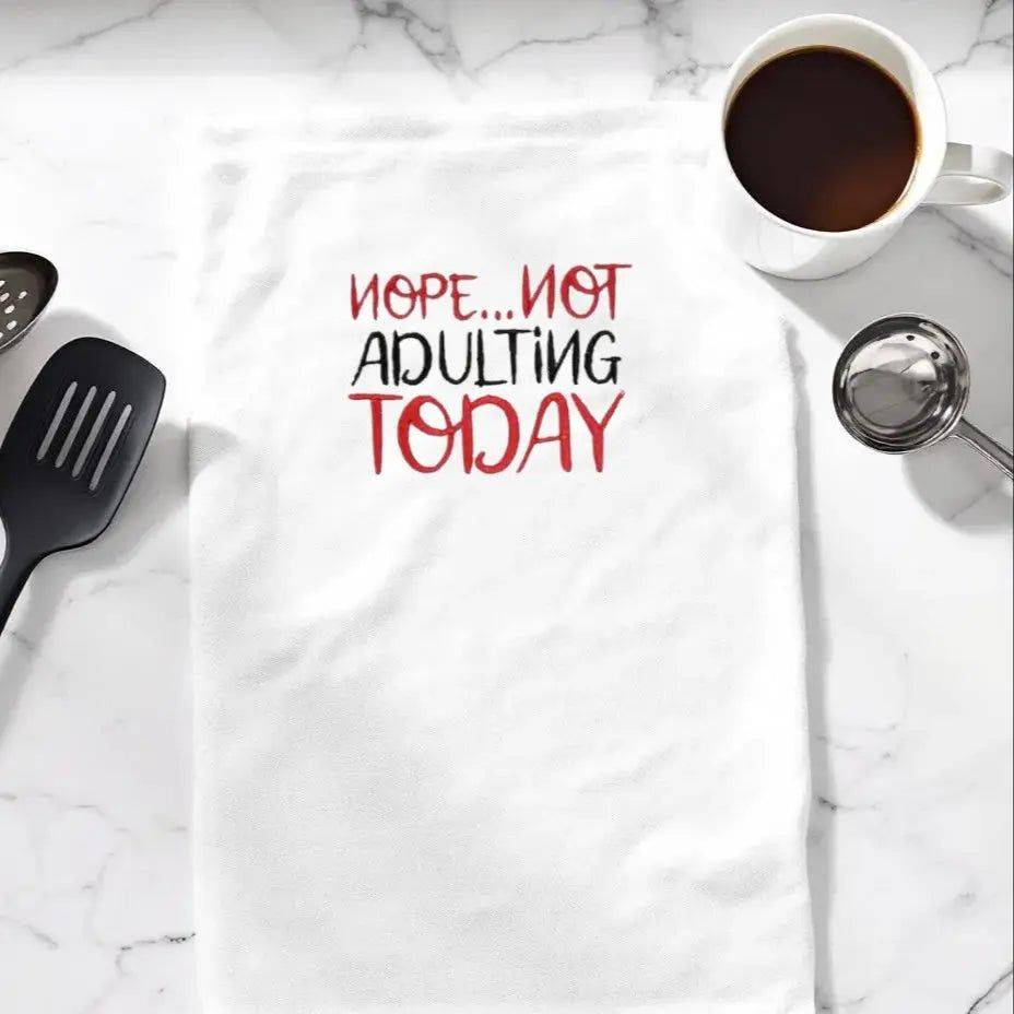Nope... not adulting Towel - Funny Embroidered Towel on marble kitchen counter with utensils and coffee, ideal for gifting or daily kitchen use.