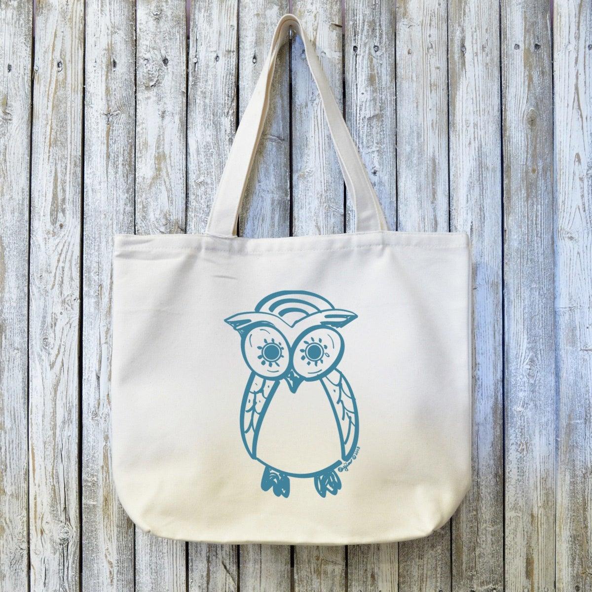 Owl Lovers Organic Tote Bag in natural canvas with blue hand-drawn owl design, eco-friendly and handcrafted for sustainable everyday use.