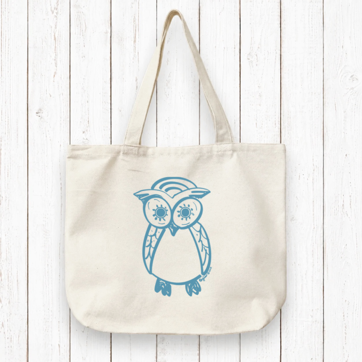 Owl Lovers Organic Tote Bag in natural canvas with blue hand-drawn owl design, eco-friendly and handcrafted for sustainable everyday use.