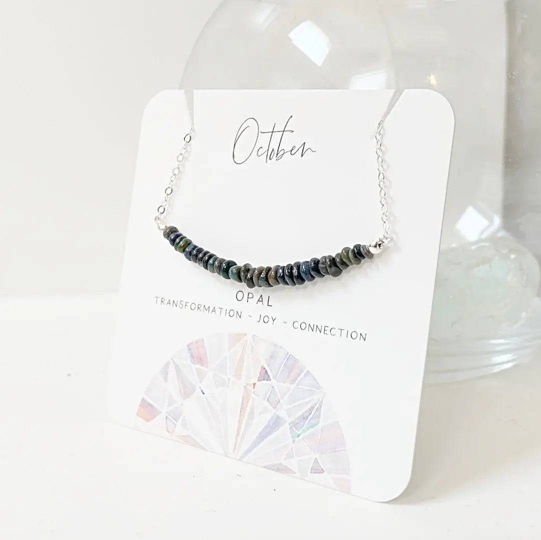 Opal Bar Necklace on branded card labeled 'October' with gemstone meanings, ideal for gifting or display.