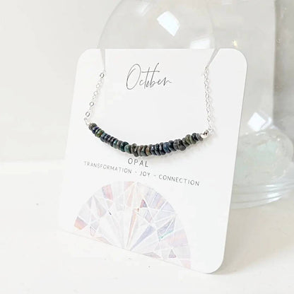 Opal Bar Necklace on branded card labeled 'October' with gemstone meanings, ideal for gifting or display.