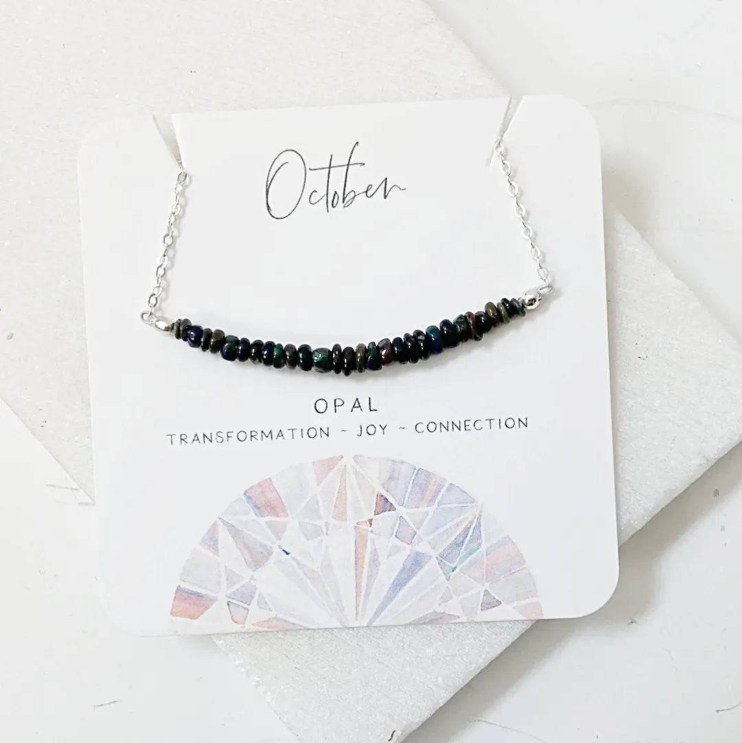 Opal Bar Necklace on a presentation card highlighting opal's symbolism of transformation, joy, and connection.