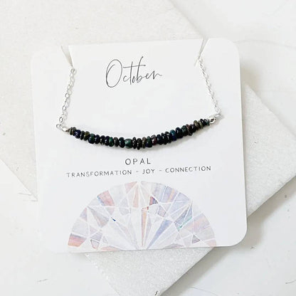 Opal Bar Necklace on a presentation card highlighting opal's symbolism of transformation, joy, and connection.