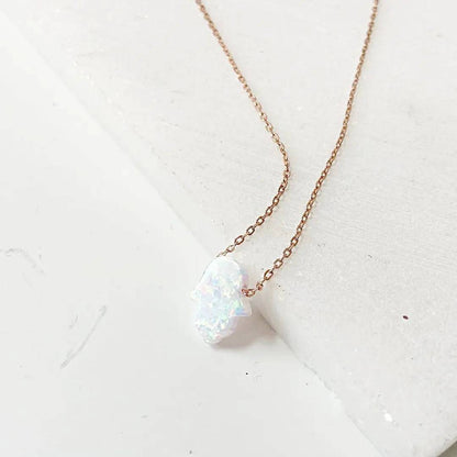 Sterling Silver Opal Necklace with shimmering Hamsa-shaped charm, perfect October birthstone accessory for minimalist jewelry lovers.