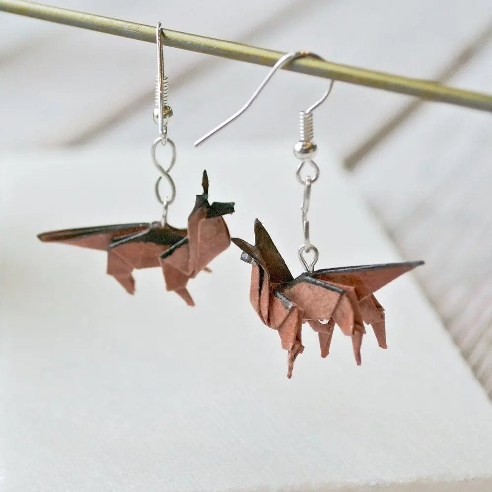 Saddle brown Origami Dog Earrings hanging from a display rod, showcasing detailed paper-folded dog design and silver-tone hooks.