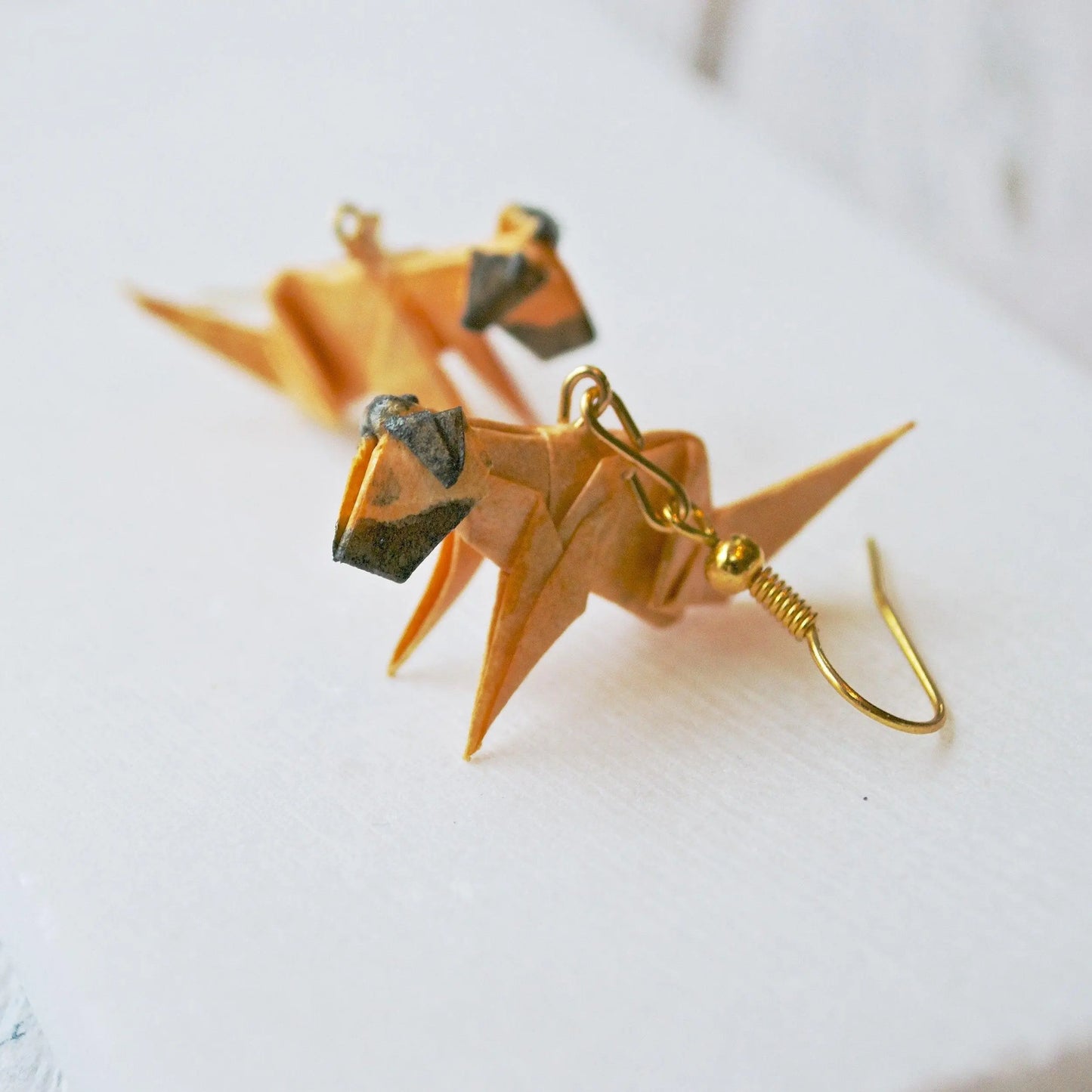 Origami Dog Paper Earrings in tan and brown with gold hooks, handcrafted and sealed for durability, ideal for dog lovers and artful accessories.