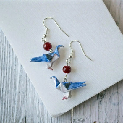 Origami Paper Dove Earrings in blue with red bead accent. Lightweight and sealed for durability, perfect for unique everyday style.