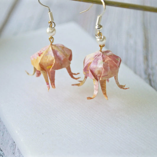 Origami Jellyfish Earrings - Elegant Paper Jewelry featuring pink and gold paper jellyfish with curled tentacles and pearl accents.