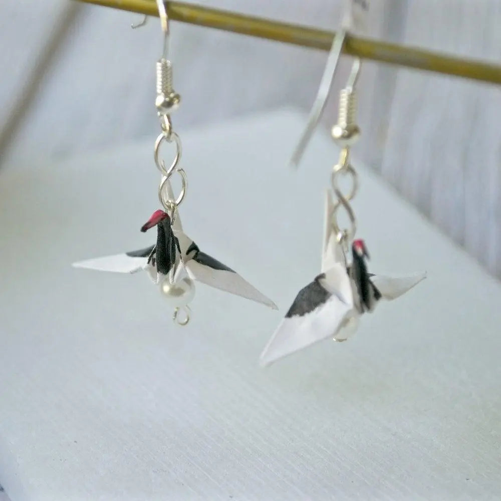 Handmade origami red crested crane earrings with black and red detailing, showcasing intricate paper folding and elegant drop design.