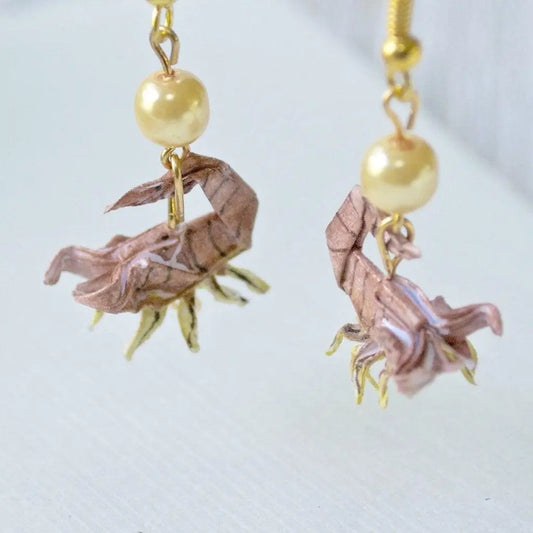 Origami Scorpion Earrings with intricate paper design and gold-tone hooks, featuring pearl accents for a unique and artistic accessory style.