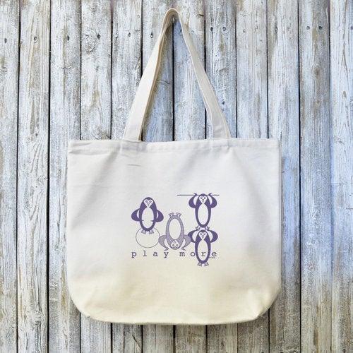 Penguin Gift Organic Tote Bag - Play More Design in eco-friendly canvas featuring playful penguin artwork. Ideal for daily use or gifting.