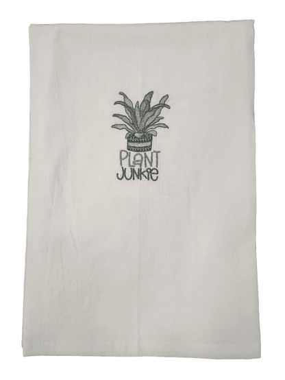 Close-up of Plant Junkie Embroidered Towel featuring potted plant and text. Ideal kitchen towel for plant lovers and humorous home décor.