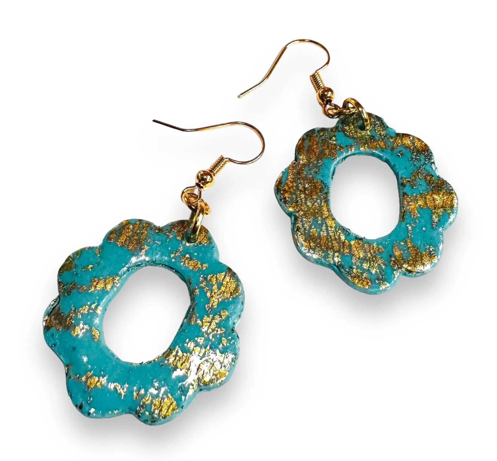 Turquoise floral-shaped polymer clay earrings with shimmering gold leaf, featuring gold plated hooks for stylish gifting.
