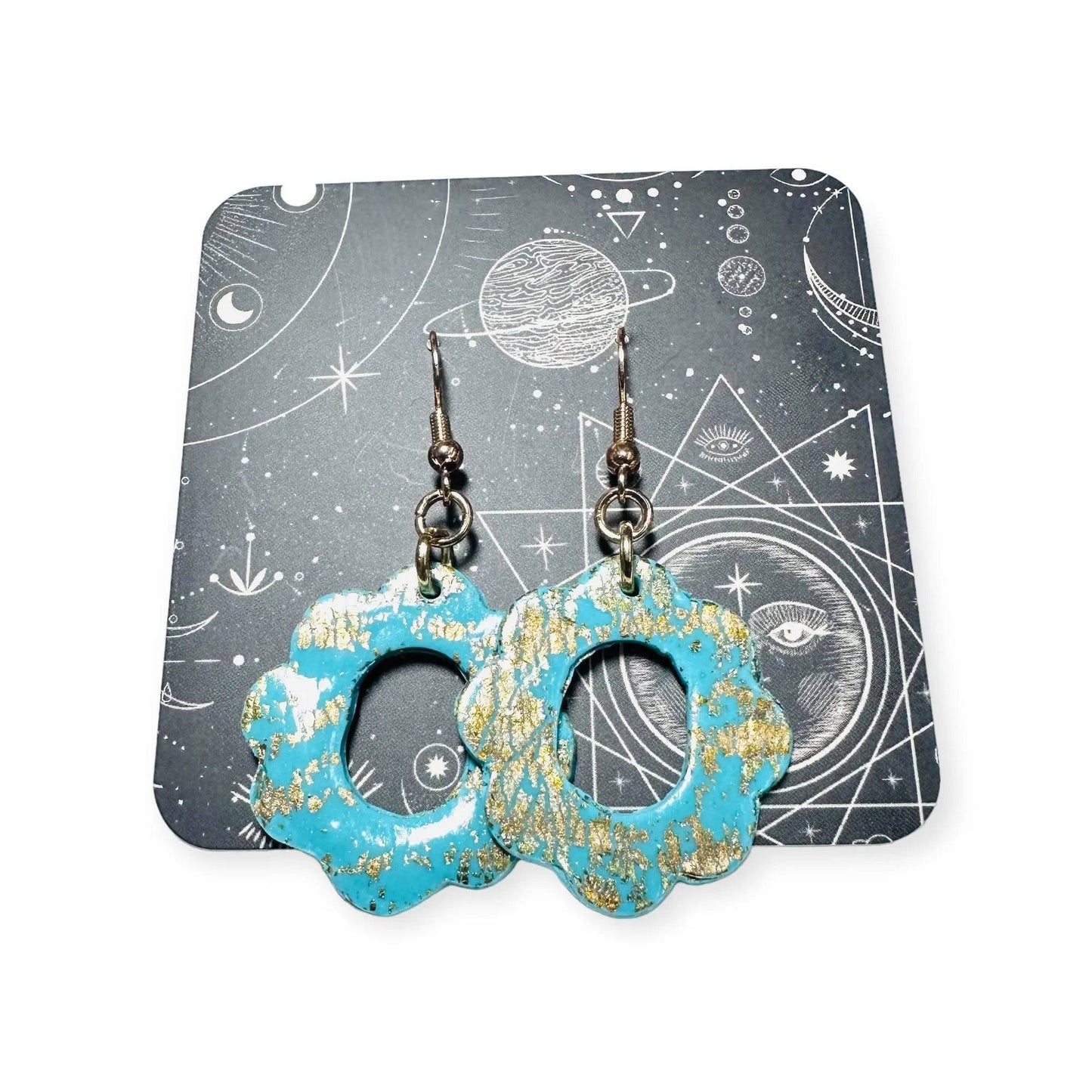 Turquoise floral polymer clay earrings with gold leaf on a celestial-themed backing card, perfect for gifting and display.
