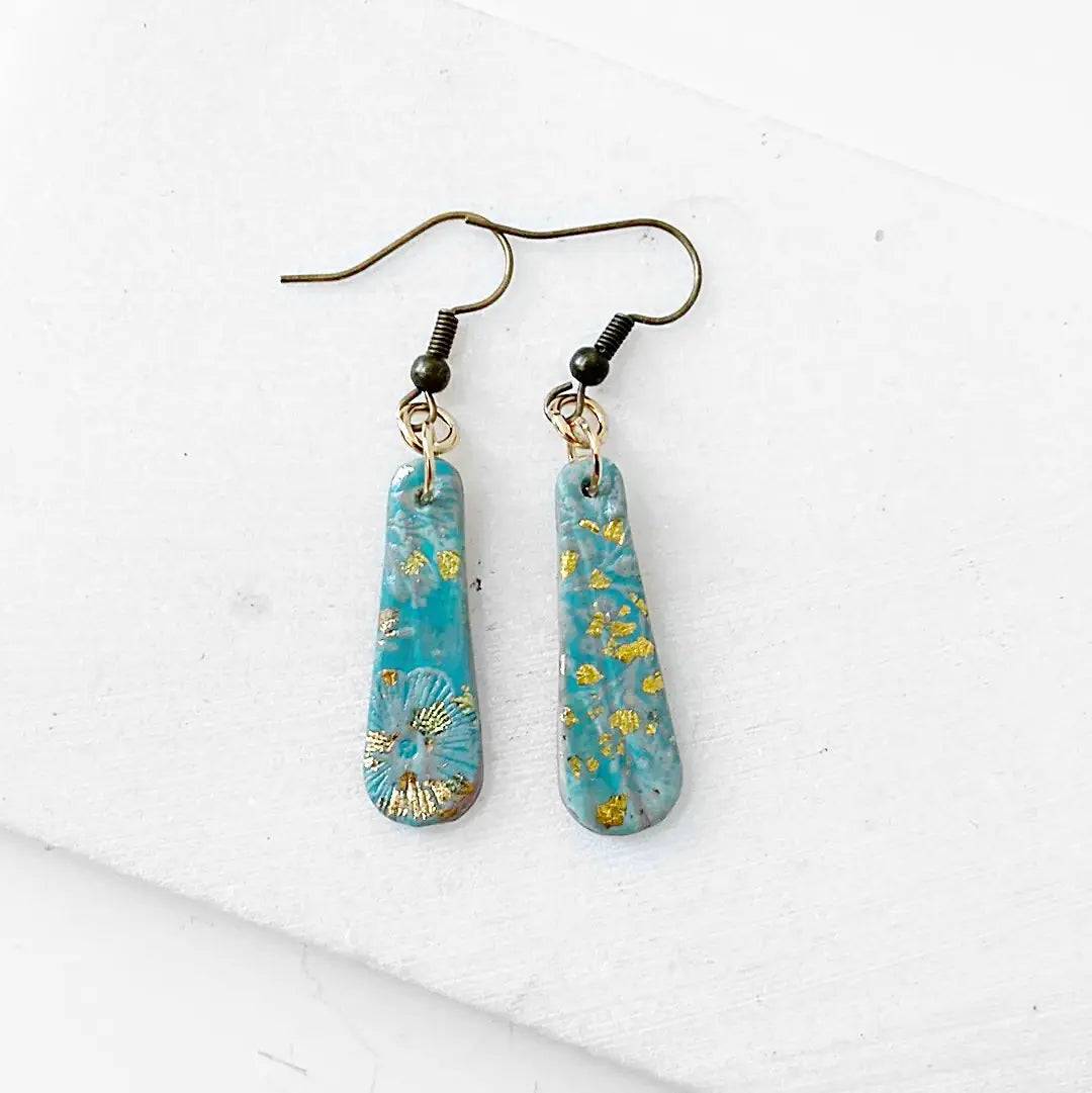 Turquoise polymer clay earrings with gold flecks and floral imprint. Lightweight and affordable gift idea.
