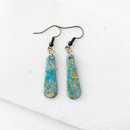 Turquoise polymer clay earrings with gold flecks and floral imprint. Lightweight and affordable gift idea.