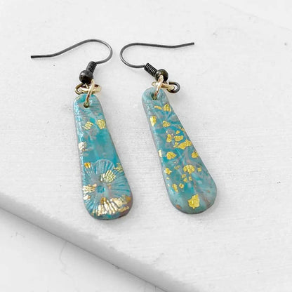 Affordable turquoise polymer clay earrings with gold accents and floral detail. Ideal for gifting or daily wear.