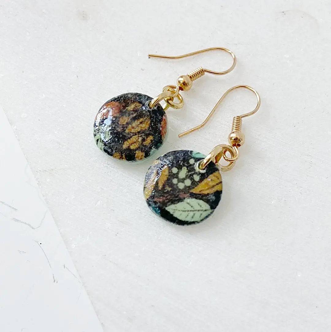 Handmade polymer clay earrings with black base and multicolor leaf design. Affordable and artistic gift choice.
