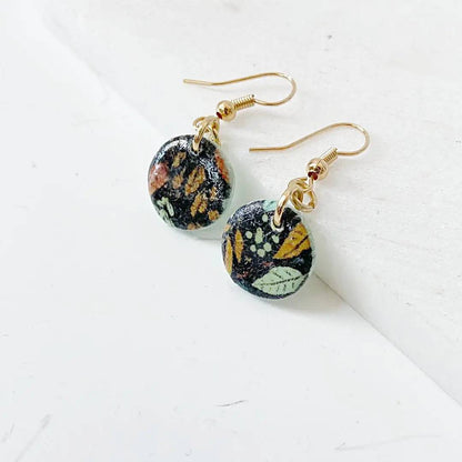 Round polymer clay earrings with botanical print and gold plated earwires. Stylish and budget-friendly gift.