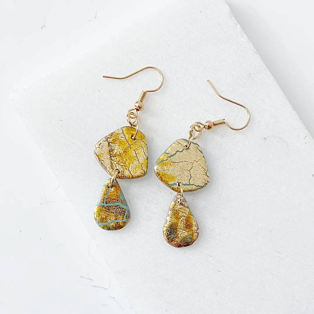 Double drop polymer clay earrings in gold shimmer with geometric shapes. Affordable and elegant gift option.