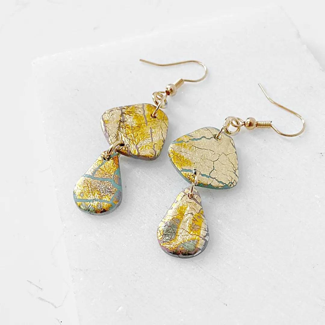 Gold Shine polymer clay earrings with layered drop design and shimmer finish. Perfect for gifting or accessorizing.