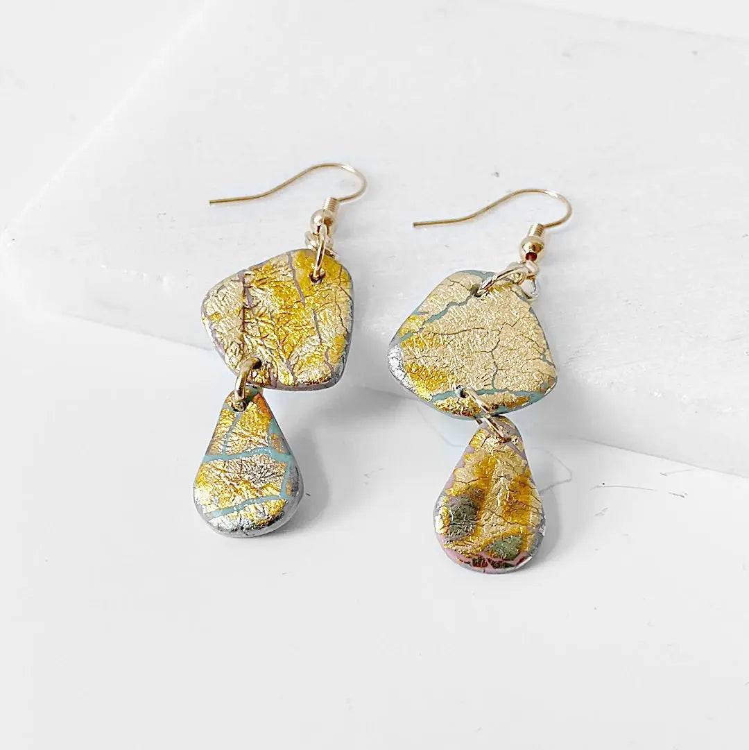 Geometric polymer clay earrings with gold shimmer and dual drop shapes. Affordable and stylish gift idea.
