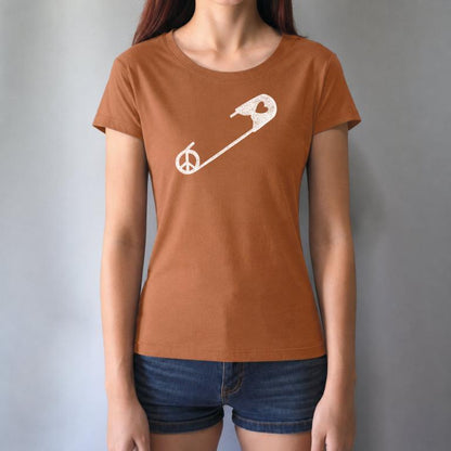 Rust-colored Women's Peace & Love T-Shirt with white safety pin design, worn by model. Ethical fashion statement for unity and kindness.