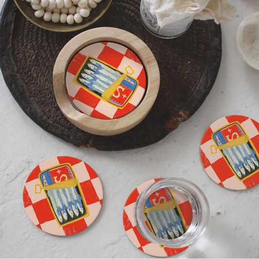 Set of red and white sardine-themed coasters on table, showcasing playful barware options for kitchen or dining decor.