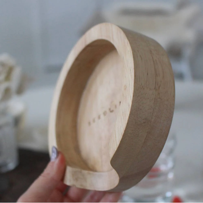 Wooden coaster holder with smooth finish, designed to store and organize round corked-backed coasters neatly.