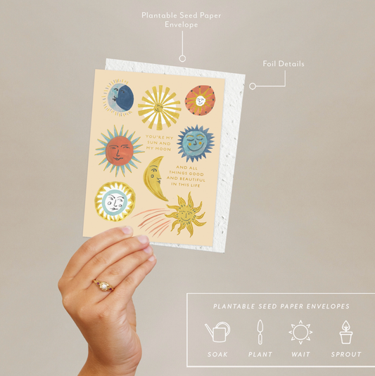 Hand holding Sun and Moon Card with plantable seed paper envelope, highlighting foil details and sustainable greeting card design.