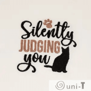 Close-up of Silently Judging You Towel - Cat Embroidered | Kitchen Sass featuring black cat and paw print, great for humorous kitchen accents.