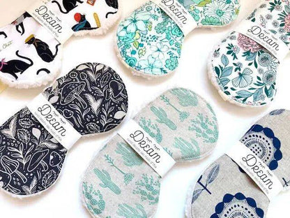 Assorted cotton sleep masks for relaxation in various patterns including floral and botanical prints. Soft Sherpa lining and elastic bands for comfort.