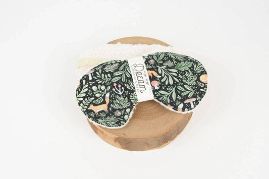 Sweet Dreams Sleep Mask by Fox + Toadstool with forest animal cotton print and cream minky backing, displayed on a wooden stand. Ideal for restful sleep.