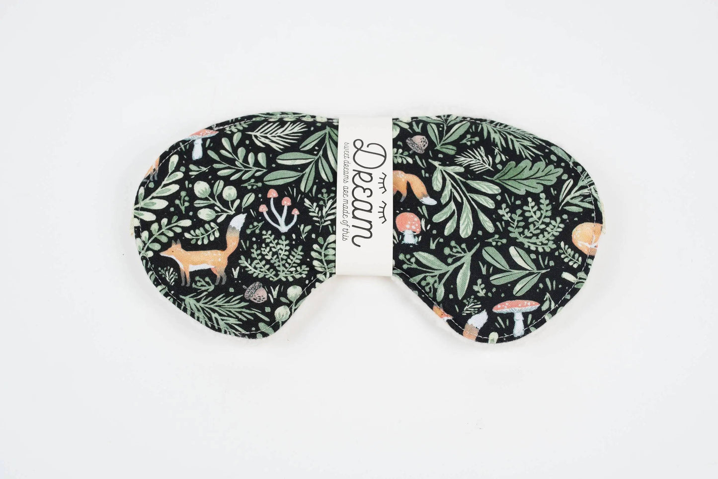 Front view of Sweet Dreams Sleep Mask featuring a whimsical forest animal and foliage design on soft black cotton. Perfect for blocking light during sleep.