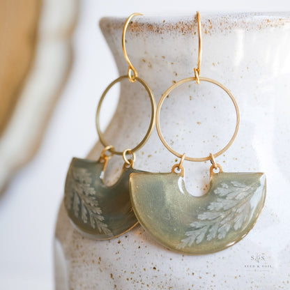 Close-up of Emerald Earrings - Fern Moon Shadow showing detailed fern leaf design in green resin with gold hoop, handcrafted holiday jewelry.