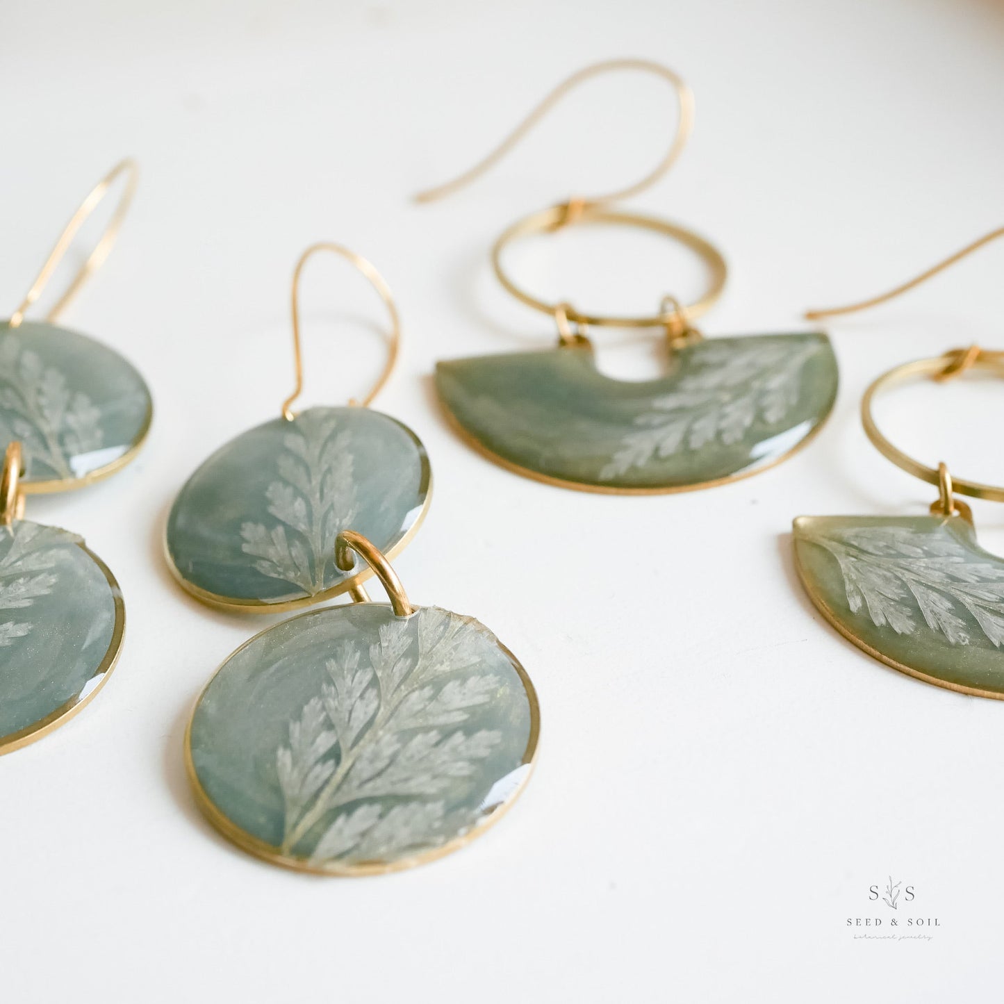 Assorted Fern Moon Shadow Earrings in round and semi-circle shapes with emerald resin and fern design, artisan holiday collection by Seed&SoilShop.