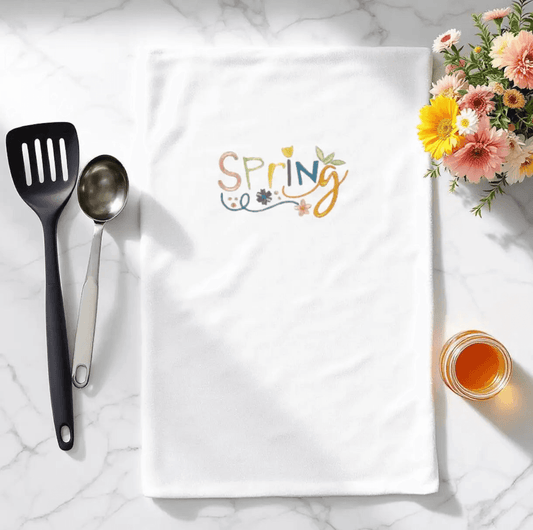 Spring Embroidered Towel - Embroidered Kitchen Towel | Durable, shown on marble countertop with utensils and flowers, ideal for seasonal kitchen decor.
