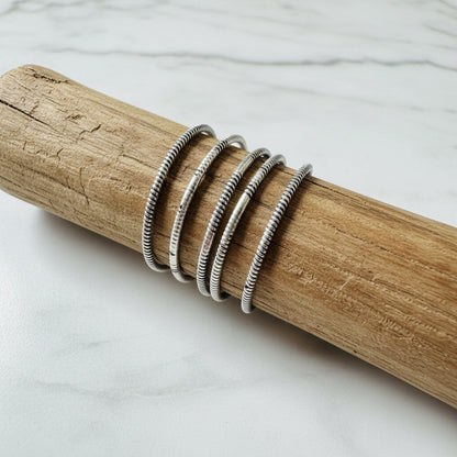 Silver Twist Pattern Ring on wood