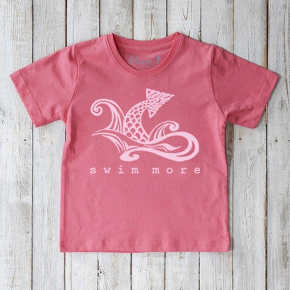 Eco-friendly Kids' Swim Organic Cotton T-Shirt in pink featuring white swimmer graphic and 'swim more' slogan, ideal for young swimmers.