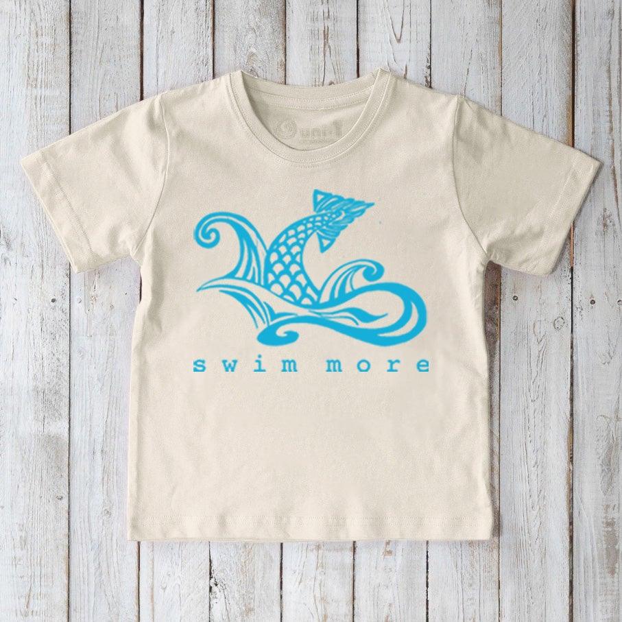 Sustainable Kids' Swim Organic Cotton T-Shirt in cream with blue swimmer graphic and 'swim more' text, perfect for water-loving kids.