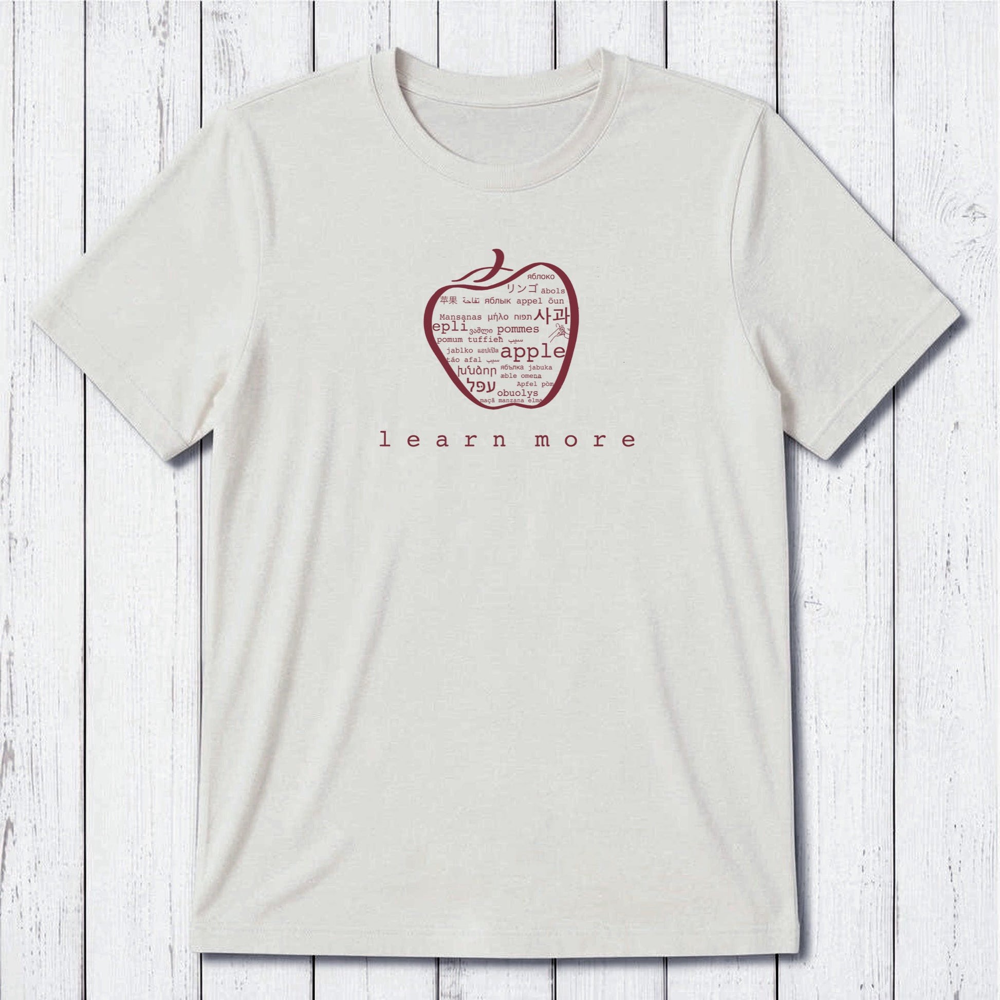 White Uni-T Inspirational Graphic Tee for men with green apple graphic and 'learn more' slogan, sustainable gift for educators.