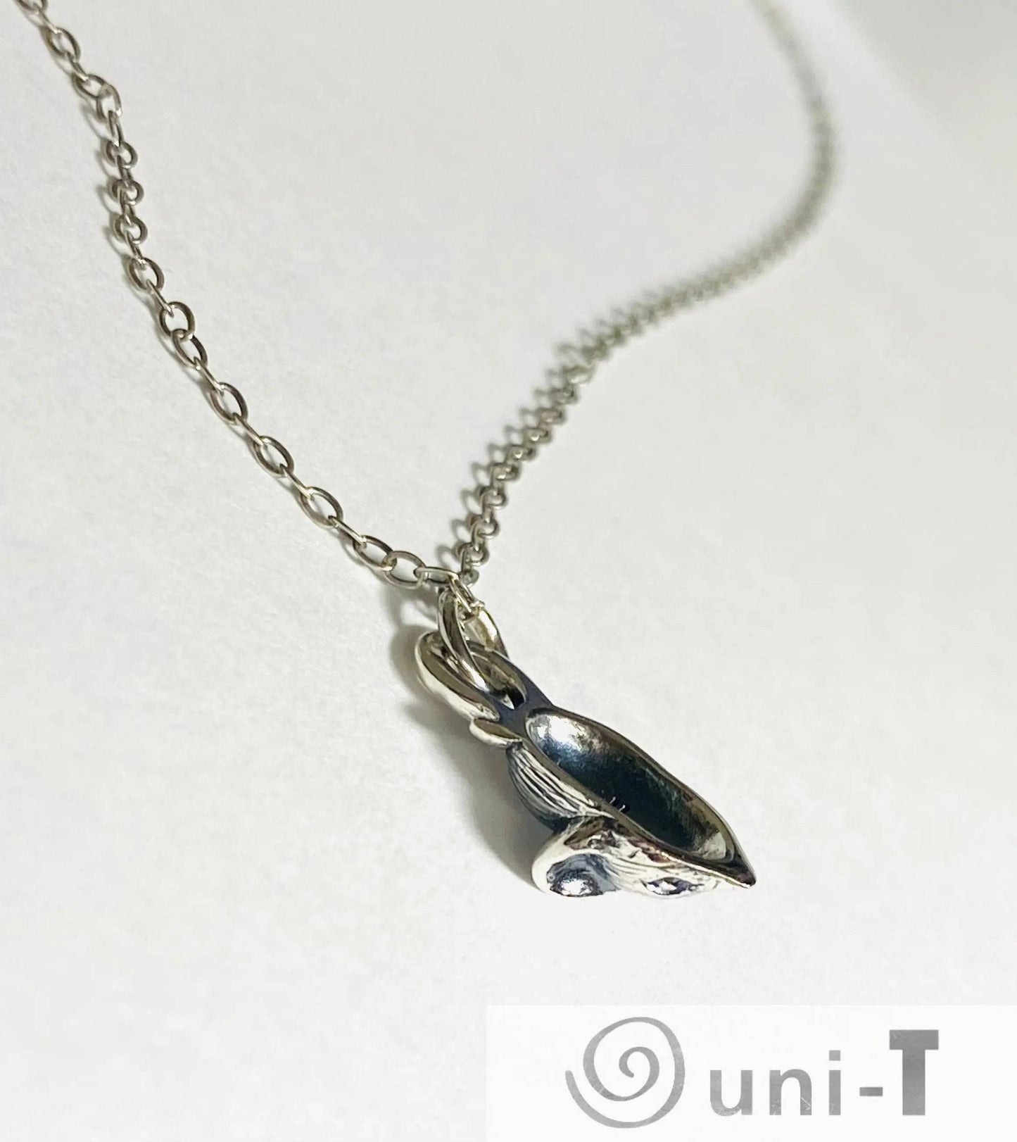 Close-up of Silver Mouse Necklace, Delicate Chain and Mouse Pendant, Jewelry Accessory
