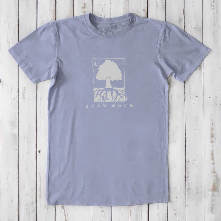 Lavender men's 'Grow More' tree graphic tee in bamboo and organic cotton, laid flat on whitewashed wooden surface.