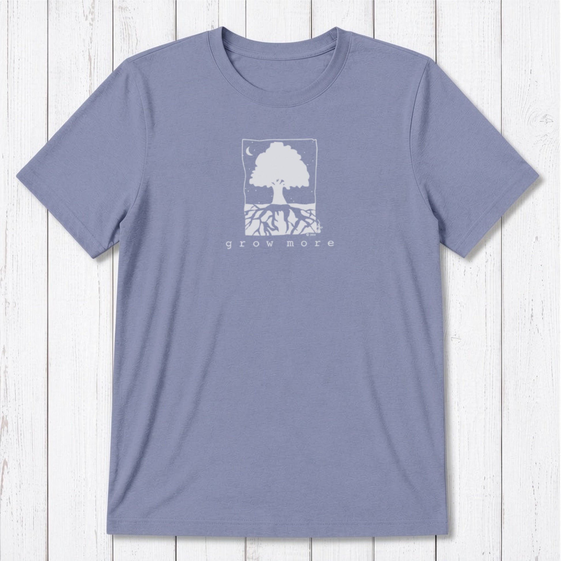Lavender men's 'Grow More' tree graphic tee in bamboo and organic cotton, laid flat on whitewashed wooden surface.