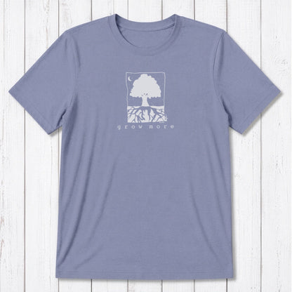 Lavender men's 'Grow More' tree graphic tee in bamboo and organic cotton, laid flat on whitewashed wooden surface.