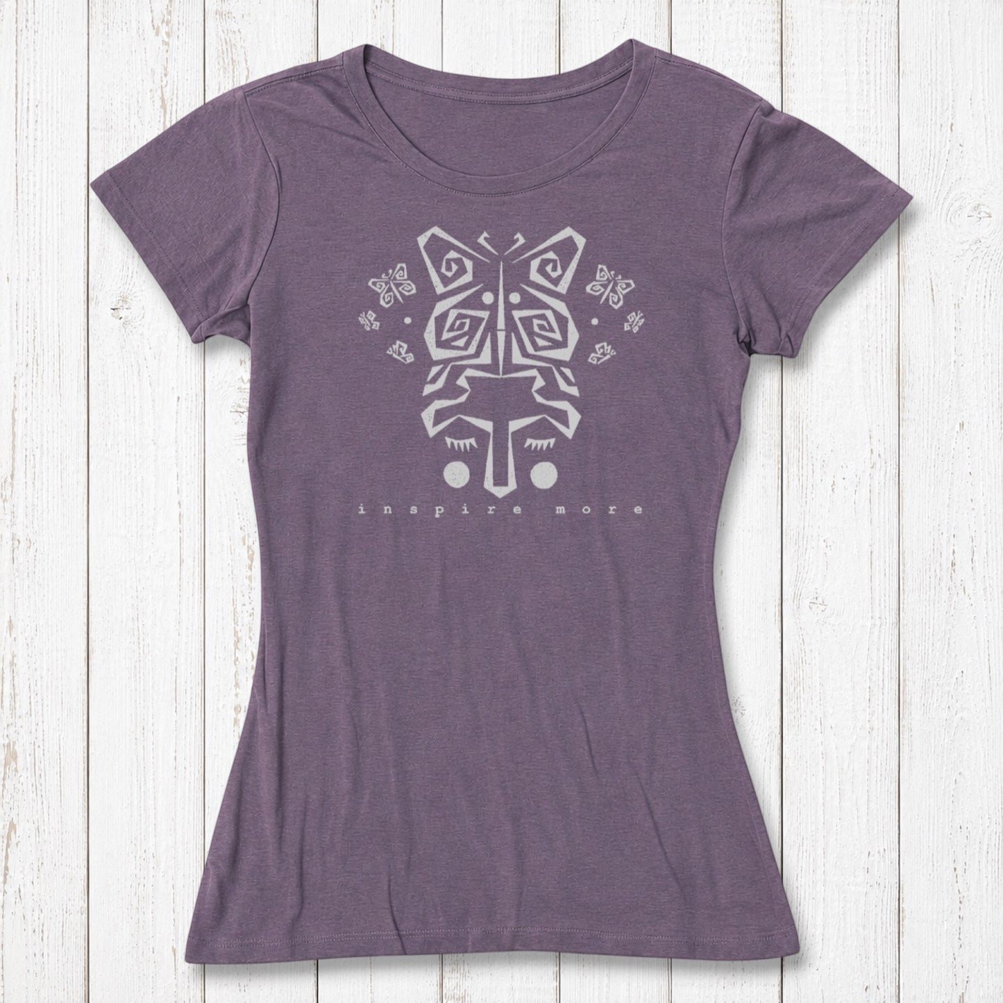 Purple women's bamboo and organic cotton t-shirt with light butterfly face design and 'Inspire More' text. Inspirational and eco-friendly fashion piece.