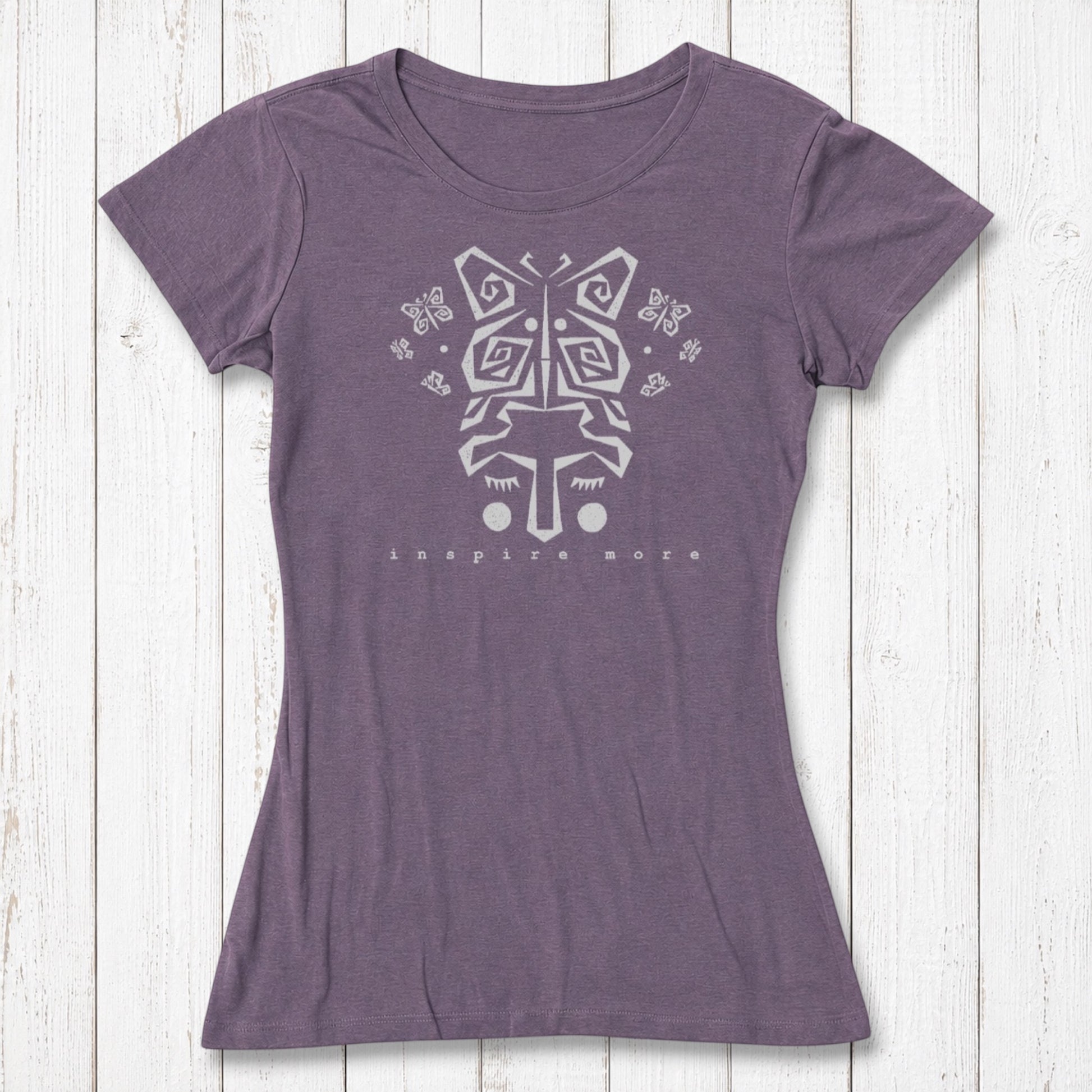 Purple women's bamboo and organic cotton t-shirt with light butterfly face design and 'Inspire More' text. Inspirational and eco-friendly fashion piece.